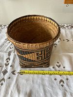 Front view of the wicker basket with a measuring tape showing width about 6 inches.