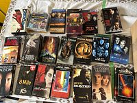 Photo showing an assortment of VHS tapes with titles including Star Trek, Donnie Darko, The Good Mother, and others. VHS cases show wear.