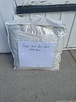 Duvet inside clear plastic storage bag with a white label saying 'Pacific Coast Duvet Double Queen'.