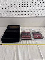 View of four brand new pairs of Crystal Visions reading glasses in original packaging and black display case with four compartments.