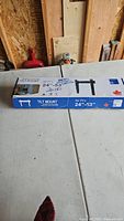 Tilt TV mount in its original box, showing the packaging with product details including compatibility for 24" to 53" TVs, ultra slim design, and made in Canada.