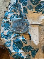 Tropical leaf patterned inflatable pool float with inflation valve in packaging