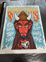 Front view of the Melvins tour poster showing stylized devil artwork with flames and skull and text.