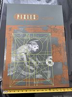 Front view of the Pixies Doolittle poster showing the entire design and size comparison with ruler at bottom.