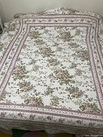 Full view of the reversible floral bedspread laid on a bed, showing the floral pattern and border design on the top.