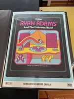 Front view of the colorful Ryan Adams and The Unknown Band 2017 concert poster with graphical artwork and concert details.