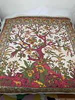 Full view of the square cotton fabric piece with central tree and floral design, laid flat.