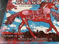 Close-up photo of the lower left section of the concert poster showing skeletal horse rider, event date and location details.
