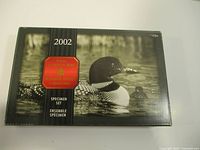 Closed black box with loon image and red Royal Canadian Mint emblem showing the 2002 Specimen Set label.