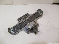 Full view of Bauer metal foot measuring device showing length and width measuring scales with sliding pointer.