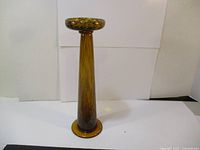 Front view showing full height and taper of the amber glass candle holder.