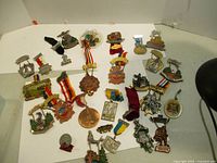 Photo of assortment of vintage Wunderlust medals with various ribbons and designs spread on a white background