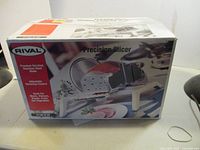 Original box of Rival Precision Slicer showing product image and key features.
