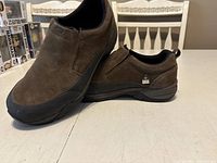 Side view of brown Dakota men's slip-on steel toe shoe showing suede upper, rubber toe cap, and sole.