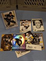 Full lot of 10 Sidney Crosby hockey cards displayed on a table showing various card designs including holographic and portrait cards