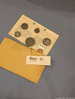 Front and back views of the uncirculated 1968 Canadian coin set in original sealed plastic packaging and accompanying envelope.