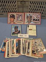 Photo showing multiple 1970-1990s MLB baseball cards, featuring Nolan Ryan, Cal Ripken Jr., Bo Jackson and a note with some details about the collection.