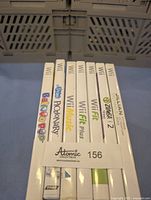 Seven Nintendo Wii game cases shown upright with sideways spine view including titles PopStar Pictionary, Wii Music, Wii Fit Plus, Zumba Fitness 2, Jillian Michaels Fitness Ultimatum 2009 among others.
