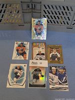 7 different Connor McDavid hockey cards arranged on a surface. Cards include holographic, gold frame, franchise pet styles.