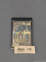Front view of the Full Art Gyarados EX card protected in the Ultra Pro case on a grey surface with seller's lot tag.