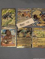 Photo of seven Full Art Pokemon EX and Trainer cards including Durant EX, Palossand EX Rainbow, Mustard Full Art Trainer, Tyranitar EX, Belibolt EX, and Surfer Trainer.