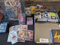 Full view of Lugia EX promo, Journey Together deck, Pecharunt promo, bulk cards in World Championship 2023 tin, energy cards, and other cards.