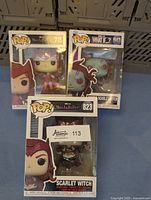 Three boxed Scarlet Witch Funko Pops: WandaVision #715, What If...? Zombie Scarlet Witch #943, and WandaVision Metallic Variant #823.