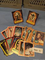 Photo showing a spread of trading cards and two sticker cards featuring C-3PO and R2-D2 upright.
