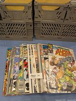 Photo of a pile of Alpha Flight vintage comics stacked together with visible spines and front covers in protective sleeves.