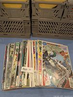 Lot of 28 vintage Green Lantern comic books stacked vertically with front covers mostly visible, protected by plastic sleeves.