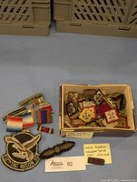 Box with assorted WW2 embroidered rank pips and patches, military ribbons including a WW2 Canadian Volunteer Service Medal ribbon, and tactical recon patch