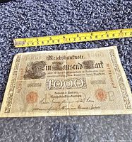 Front side of the 1910 German Empire 1000 Mark banknote showing denomination, red seal, serial numbers, and signatures.