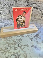 Front view of Guy Gendron 1958 Topps hockey card placed in wooden stand (not included)