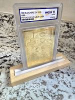 Front view of the 1998 KISS Psycho-Circus 23K gold card encased in graded slab, showing embossed details.