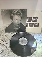 Front cover of Bryan Adams Reckless album showing monochrome portrait of Bryan Adams.