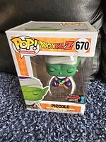 Piccolo Funko Pop figure in original box, clear front showing the figure inside, box numbered 670 and labeled Pop! Animation DragonBall Z.