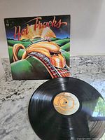 Vinyl record with cover artwork showing stylized train under colorful sky