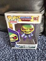Photo of new Masters of the Universe Battle Armor Skeletor Funko Pop figure inside pop protector and original box showing front and box details including number 563.