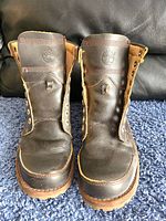 Front view of men's Timberland brown leather boots with no laces.