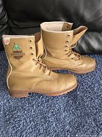 Side profile view of the tan WORKGARD steel toed boots showing the brand patches and lace-up design