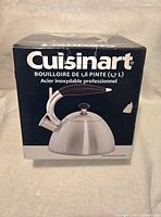 Closed box of Cuisinart whistle kettle showing front and top side with brand and product info.