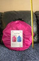 Packed Royal Castle play tent in magenta colored storage bag, showing packaging label.