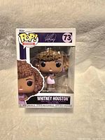 New Whitney Houston Funko Pop figure in original window display box, showing figure and packaging details.