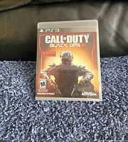 Front cover of PlayStation 3 Call of Duty Black Ops III video game case on carpeted surface