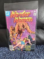 Front cover of Wonder Woman comic issue 238 from December 1977, showing Wonder Woman facing an attacking mountain lion with text 'Kung Assassin with a Thousand Claws!'