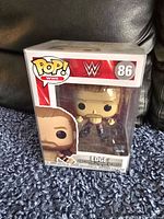 Image of WWE Edge Funko Pop figure number 86 in original box with protective pop protector.
