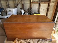 Closed cedar chest showing flat lift-top surface and wood grain finish.