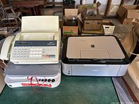 Lot showing three small office machines on a floor: Brother Intellifax 1270 fax machine, Canon PC170 personal copier, and Canon Pixma printer/scanner/copier.
