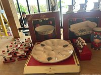 Lenox baking dishes in boxes with Spode deviled egg platter and wooden Santa napkin holders