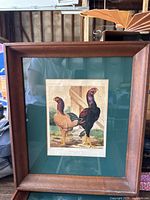 Framed print showing two chickens, one gold-brown and one black, titled 'Henry Beldon's Pair of Golden-Pencilled Hamburghs' in a wood frame with green matting.